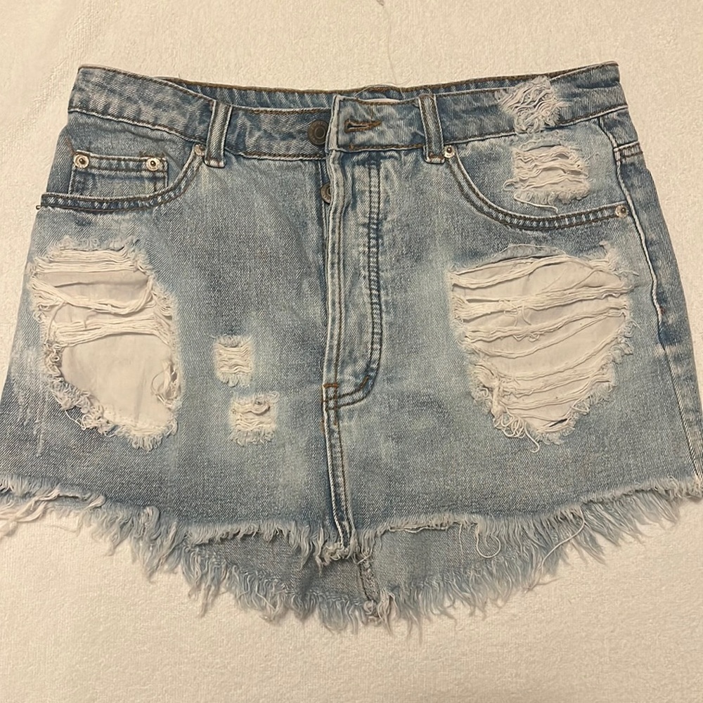 Distressed denim mini skirt